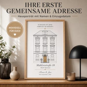 May include: A framed wall art print featuring a black and white line drawing of a multi-story house with a gold-colored door. The text reads: IHRE ERSTE GEMEINSAME ADRESSE, Hausporträt mit Namen & Einzugsdatum, ZUHAUSE IST EINE ADRESSE IM HERZEN, Mühlenstraße 18, 48629 Metelen, Anna & Jan, Seit September 2026.