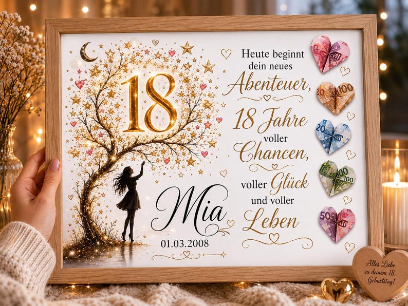 May include: A framed print featuring a gold tree with stars, the number 18, and the name Mia with the date 01.03.2008. The text reads: Heute beginnt dein neues Abenteuer, 18 Jahre voller Chancen, voller Gl&uuml;ck und voller Leben. Five origami hearts made from banknotes are attached to the right side.