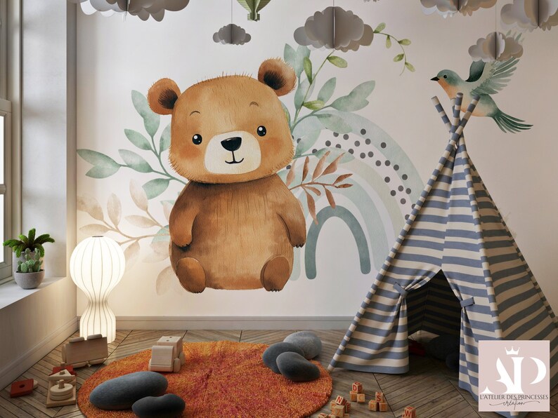 May include: A brown teddy bear with a watercolor rainbow and green leaves on a white wall. A blue and white striped teepee tent is in the foreground.