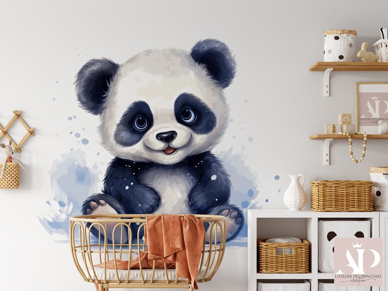 May include: A watercolor illustration of a cute panda bear with black and white fur, sitting in a crib with a brown blanket. The background is a light blue watercolor wash.