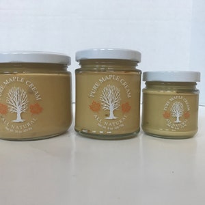 May include: Three glass jars of pure maple cream, all natural. The jars are different sizes, with the largest jar being 16 oz, the middle jar being 8 oz, and the smallest jar being 4 oz.