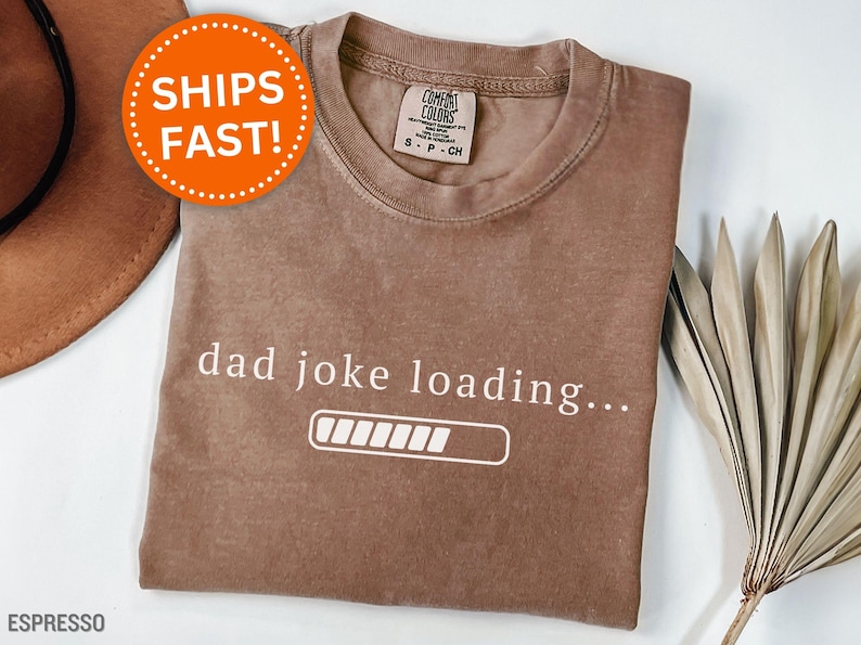 May include: Espresso-colored t-shirt with the text "dad joke loading..." and a loading bar graphic. The shirt is a Comfort Colors brand, size S-P-CH.