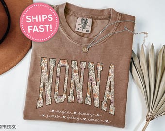 May include: A brown t-shirt with the word "NONNA" printed in white with floral accents. The names "Megan, Sammy, James, Kelsey, Connor" are printed below the word "NONNA" in white.