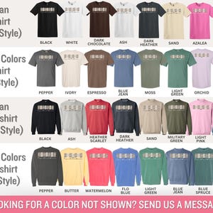 May include: A chart showing different color options for Gildan T-shirts and sweatshirts in various styles. The chart includes the Gildan 5000, 1717, 18000, and 1566 styles. The colors include black, white, dark chocolate, ash, dark heather, sand, azalea, navy, pepper, ivory, espresso, blue jean, moss, light green, orchid, violet, heather scarlet, dark heather, military green, light pink, indigo blue, butter, watermelon, flo blue, light green, blue jean, blue spruce, and violet.