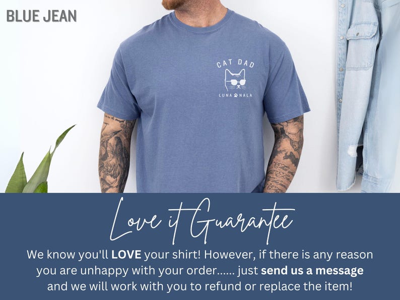 May include: Blue jean colored t-shirt with a white graphic of a cat wearing sunglasses and the text "CAT DAD" and "LUNA NALA". The shirt is made of a soft material.