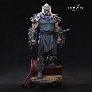 May include: A detailed figurine of Shredder, a villain from the Teenage Mutant Ninja Turtles franchise. The figure is in a dynamic pose, wearing his signature armor, helmet, and cape. The figure is standing on a platform with a red and yellow base.