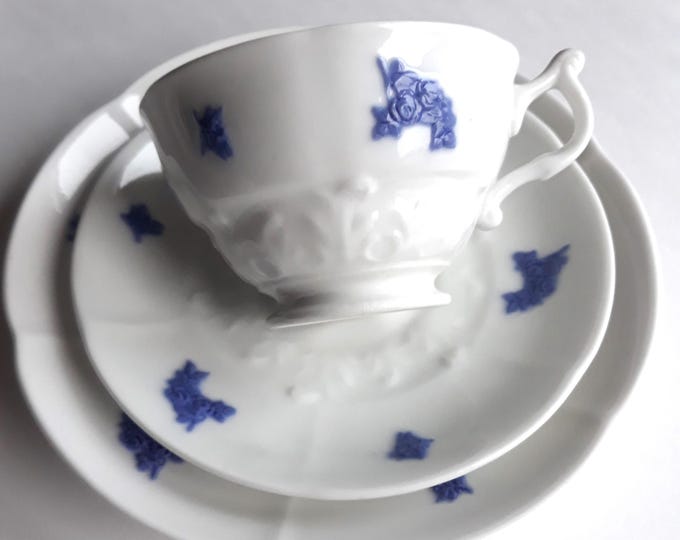 Vintage Bla Blom Pattern Trio Cup, Saucer and Cake Plate. Marked with MZ. White Base with Relief of Blue Flowers and White stylized Leaves.