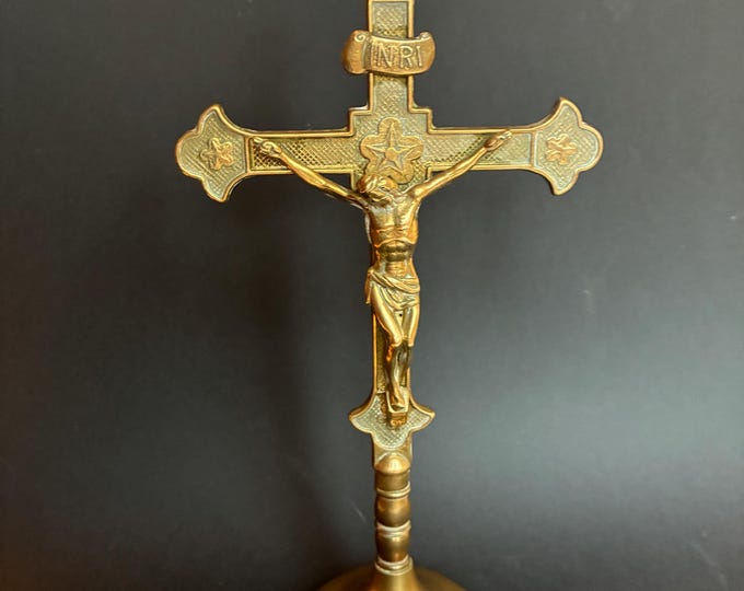 Vintage French Standing Brass Crucifix of Jesus Christ, an INRI Scroll Plaque and Star decorated Terminal Ends on a turned Pedestal Base.