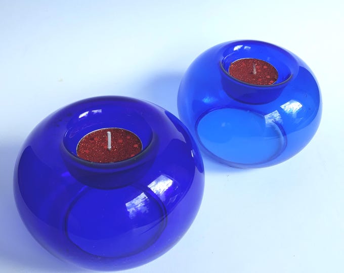 Pair of Dark Blue Glass Tealight Holders. One Smaller, the other Bigger. Simple Modern Shape. Stylish Scandinavian Glass Home Decoration.