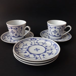 A Pair of Vintage Jäger Eisenberg Germany &#39;Blau Saks&#39; Porcelain Tea Coffee Cup and Saucer with a Strawflower Pattern in Indian Blue. GDR.