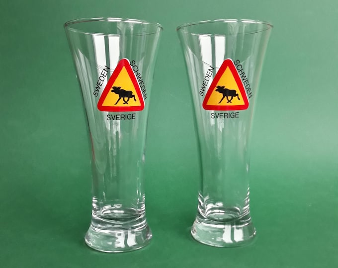 Set of 2 tall Glass Glasses featuring triangular road sign with Black Moose Silhouette, and the Words SWEDEN, SCHWEDEN and SVERIGE.