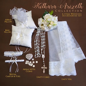 May include: A white wedding accessory set with a unity veil, unity cord, bridal garter and toss, arras with coins, ring pillow, and arras pillow. The set also includes a bouquet of white roses.