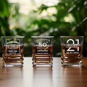 May include: Three personalized whiskey glasses filled with amber liquid, each with unique text. One glass reads "CAMERON Old No. 21 Finally Legal 09.07.2025". The second glass says "CAMERON'S 50th BIRTHDAY celebration 09.07.2025". The third glass says "21 DAISY 09.07.2025".