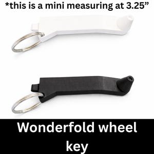 May include: A white and a black Wonderfold wheel key, each with a silver keyring. The white key is 3.25 inches long. The text "Wonderfold wheel key" is displayed in white on a black background.