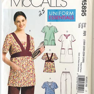 May include: McCall's M5895 sewing pattern for uniform essentials. The pattern includes various scrub top designs, trousers, and sizes 18W-24W. The main image shows a woman wearing a patterned scrub top with a burgundy accent.