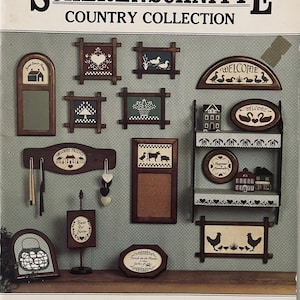 May include: A collection of 12 wooden signs with various country-themed designs, including a welcome sign, a sign with a heart, a sign with a basket, a sign with a cow, a sign with a lantern, and a sign with a rooster. The signs are all framed in brown wood and have a distressed look. The signs are arranged on a light blue background. The text on the signs reads "Welcome", "Welcome Friend", "Bless Our Home", "Friends in the Flower Garden of Life", "Happiness Never Ends", "Welcome", and "Back Street".