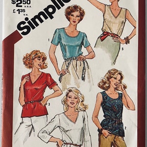May include: Simplicity sewing pattern number 5380, size 12, for a top with a V-neck and short sleeves. The pattern includes five different styles of tops, including a sleeveless top, a top with a scoop neck, and a top with a round neck.