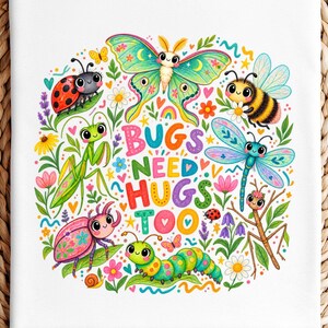 May include: A white t-shirt featuring a colorful graphic print of various insects including a butterfly, bee, dragonfly, ladybug, and caterpillar surrounded by flowers. The text in the center of the design reads BUGS NEED HUGS TOO.