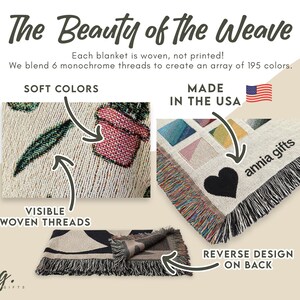 May include: A woven blanket with a cream background, featuring a plant design and a black heart. The text reads "The Beauty of the Weave" and "Made in the USA". The blanket has visible woven threads and a reverse design.
