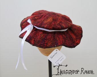 Fiery red hand felted floppy flat hat with white ribbon