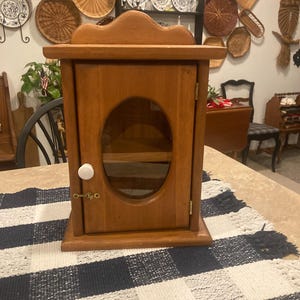 Vintage wood curio/apothecary/medicine cabinet with porcelain knob with oval glass window