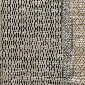 Puede incluir: Primer plano de una tela beige con un patr&oacute;n geom&eacute;trico en blanco y negro. La tela tiene un borde con un patr&oacute;n geom&eacute;trico gris y dorado. El texto "HARMAN ART AND CRAFT" es visible en la esquina inferior izquierda.