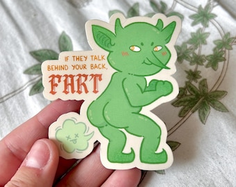 May include: Green cartoon goblin sticker with a fart cloud. The sticker says "If they talk behind your back, FART".