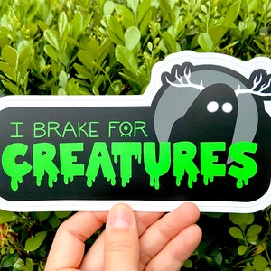 I Brake for Creatures Bumper Sticker | Cryptid Car Decal | Original Fade Weather Resistant Vinyl Sticker | spooky mothman night beast woods