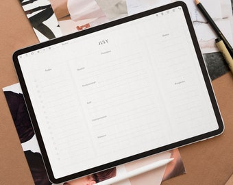 May include: A white tablet computer with a digital planner app open on the screen. The app is titled "JULY" and has sections for tasks, work, personal, and progress. The tablet is lying on a brown surface with a white stylus and two pencils.