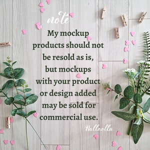 May include: A note on a wooden background with pink hearts, greenery, and clothespins. The note reads: "My mockup products should not be resold as is, but mockups with your product or design added may be sold for commercial use. Nallaolla"