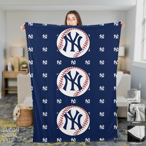 May include: A blue fleece blanket with a white baseball pattern and three large white baseballs with a red stitching and a blue "NY" logo.