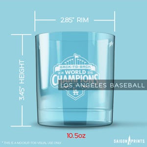 May include: A clear glass tumbler with a 2.85-inch rim and a height of 3.45 inches. The glass features a white graphic that reads "BACK-TO-BACK 24 WORLD 25 CHAMPIONS LOS ANGELES BASEBALL" and the team logo. It holds 10.5oz.
