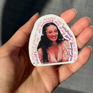 May include: A sticker with a photo of a smiling person with long dark hair. The sticker has text that reads "When people actually use violence & raise their languages, one of my love really values voices for me."