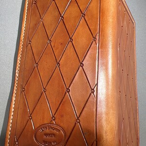 Backside. Medium brown roper style vertical wallet all 100 percent USA Herman Oak Leather.