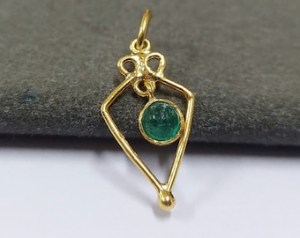 May include: A gold pendant featuring a green gemstone set within a geometric design.