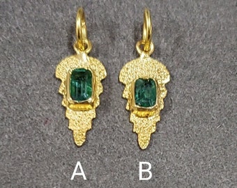 May include: Two gold pendants with a green gemstone set in each. The pendants are shaped like a leaf and have a textured surface. The pendants are labelled A and B.