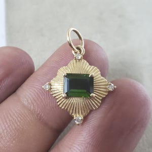 emerald cut deep green tourmaline gold pendant fine jewelry close up