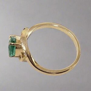 Unique Zambian emerald engagement ring with diamonds in gold setting