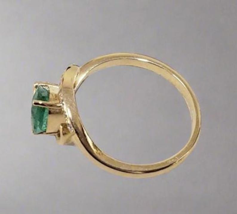 Unique Zambian emerald engagement ring with diamonds in gold setting