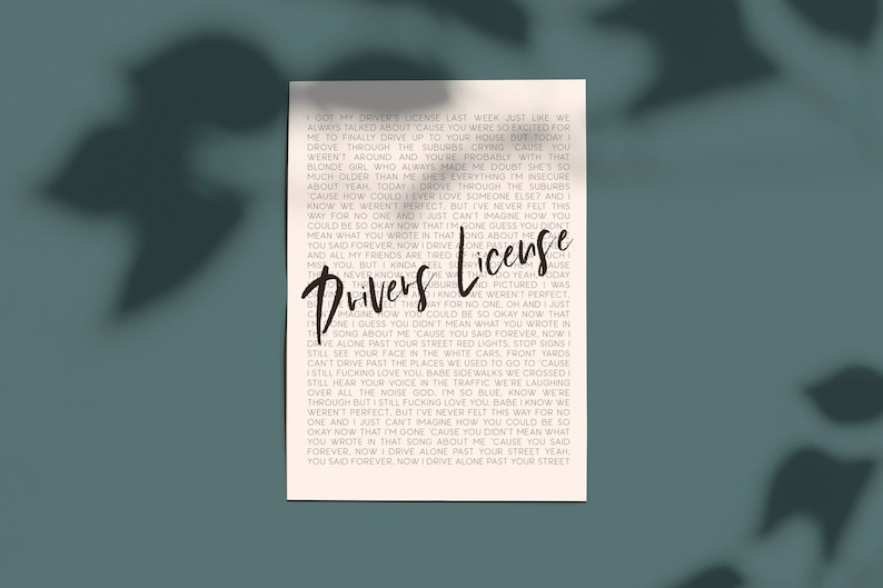 May include: Black and white text on a cream background. The text is a song lyric from the song "Drivers License" by Olivia Rodrigo. The lyrics are: "Got my driver's license last week just like we always talked about 'cause you were so excited for me to finally drive up to your house but today I drove through the suburbs crying 'cause you weren't around and you're probably with that blonde girl who always made me doubt she's so much older than me she's everything I'm insecure about yeah, today I drove through the suburbs 'cause how could I ever love someone else? And I know we weren't perfect, but I've never felt this way for no one and I just can't imagine how you could be so okay now that I'm gone guess you don't mean what you wrote in that song about me you said forever. Now I drive alone past your street red lights, stop signs I still see your face in the white cars, front yards can't drive past the places we used to go to 'cause I still fucking love you babe sidewalks we crossed I still hear your voice in the traffic we're laughing over all the noise god, I'm so blue know we're through but I still fucking love you babe I know we weren't perfect, but I've never felt this way for no one and I just can't imagine how you could be so okay now that I'm gone 'cause you didn't mean what you wrote in that song about me 'cause you said forever. Now I drive alone past your street yeah, you said forever. Now I drive alone past your street."