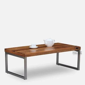 May include: A rectangular wooden coffee table with a dark brown finish and a metal frame. The table has a simple design with a rectangular top and four legs. The table is sitting on a white background.
