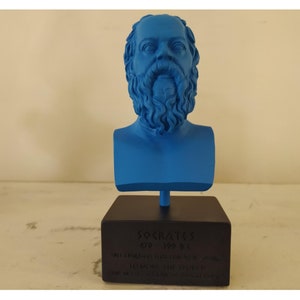 May include: A blue 3D printed bust of Socrates on a black base with the inscription "SOCRATES 470 - 399 BC" and a quote in Greek.