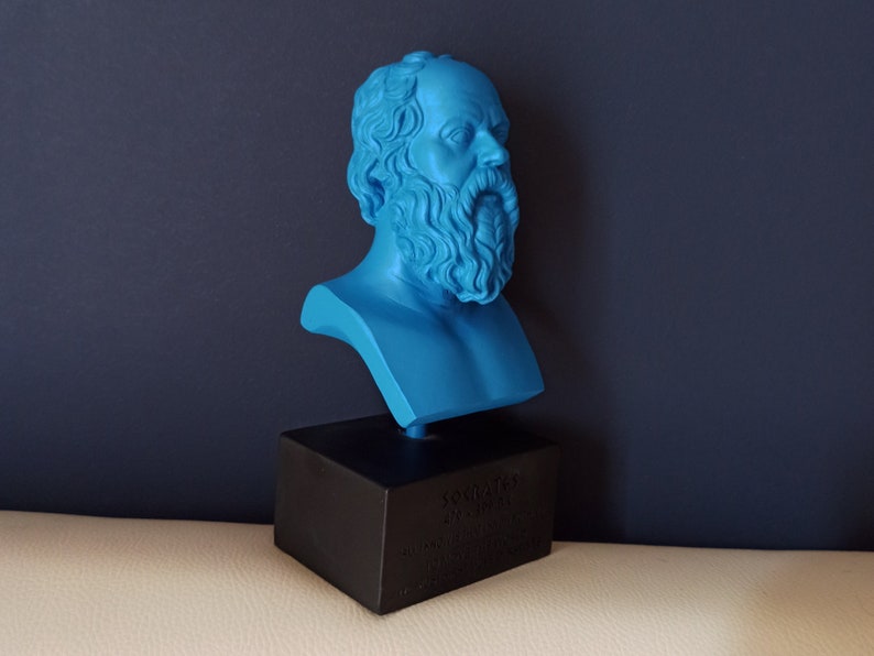 May include: A blue bust sculpture of Socrates on a black base. The base has text that reads "Socrates 470-399 BC Athenian Philosopher".