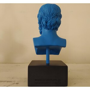 May include: A blue bust sculpture of a man's head and shoulders. The sculpture is on a black base with the text "www.artstatues.gr handmade in Greece".
