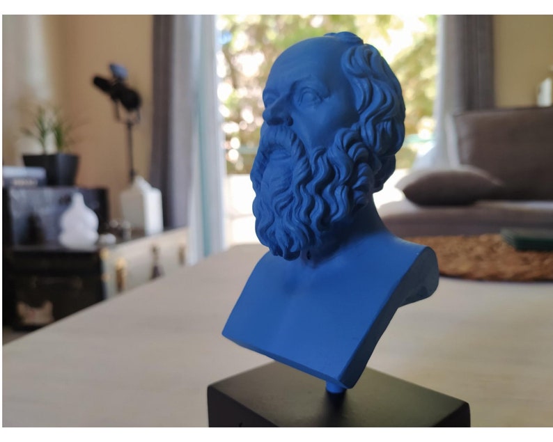 May include: A blue bust sculpture of a man with a beard and curly hair. The sculpture is on a black base.