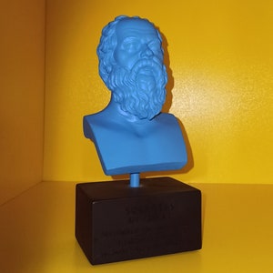 May include: A blue bust of a man with a beard on a black base with the text "The Classics" and a quote about the importance of education.