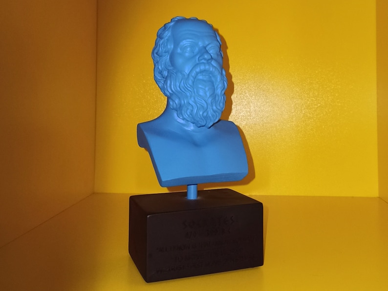 May include: A blue bust of a man with a beard on a black base with the text "The Classics" and a quote about the importance of education.