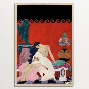 George Barbier’s erotic Art Deco illustration displayed in a minimalist light wood frame. The print features two nude women in a sensual pose, surrounded by ornate interior details like a Greek statue and floral vase, with a vivid red and black backdrop. This elegant wall art blends 1920s French fashion with bold romantic expression.