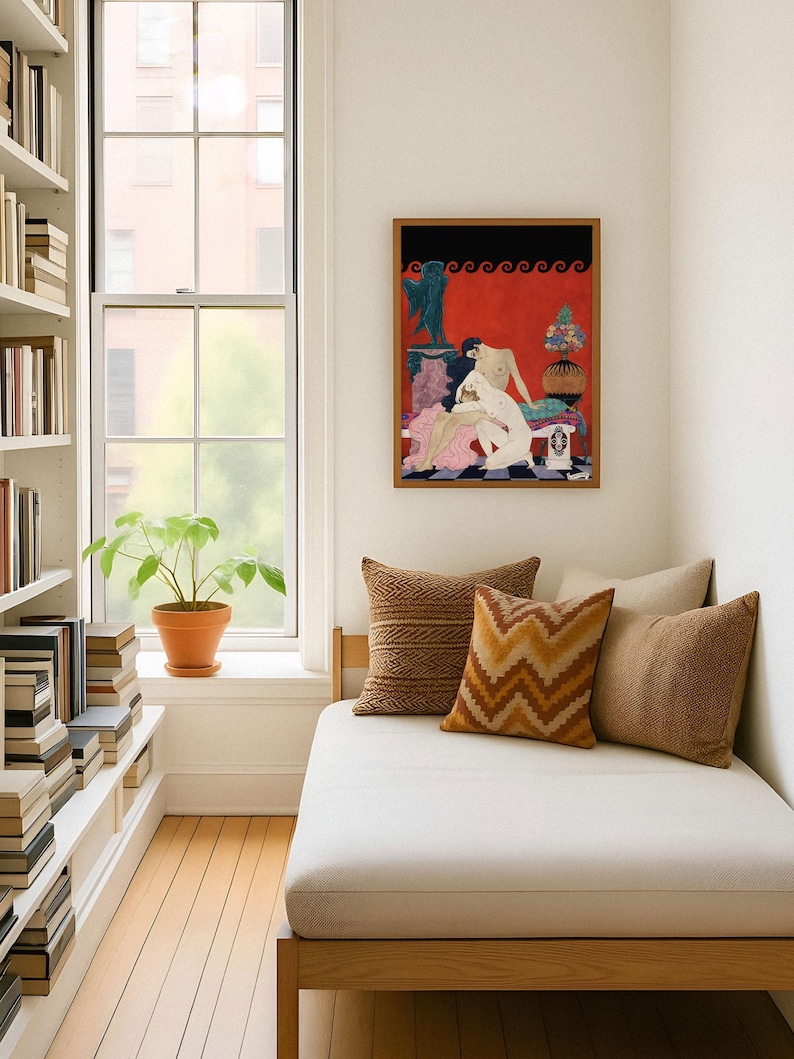 Framed George Barbier erotic illustration decorates a reading nook with large windows and neutral-toned cushions. The bold red and black Art Deco print offers an intimate glimpse into 1920s French fashion art, infusing the space with vintage romance and visual drama.