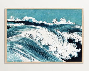 May include: A framed print of a stylized ocean wave in shades of blue and white. The artwork features a dynamic composition with swirling water and cresting waves, evoking a sense of movement and power. The print is set in a light-colored wooden frame.